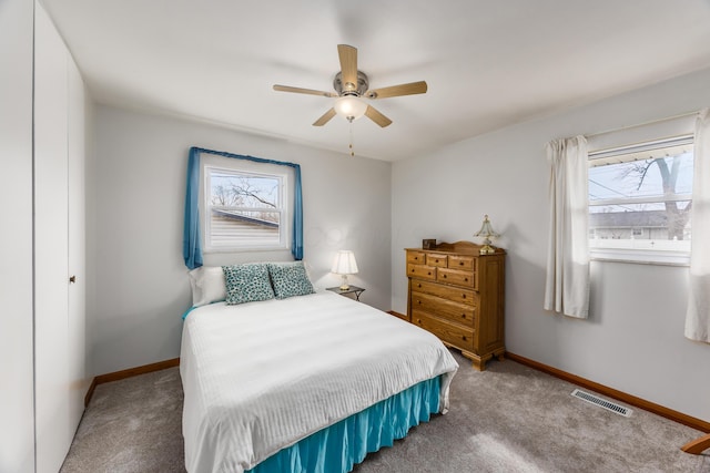 bedroom with baseboards, visible vents, ceiling fan, and carpet flooring