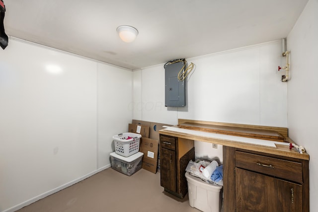 office area with concrete flooring and electric panel