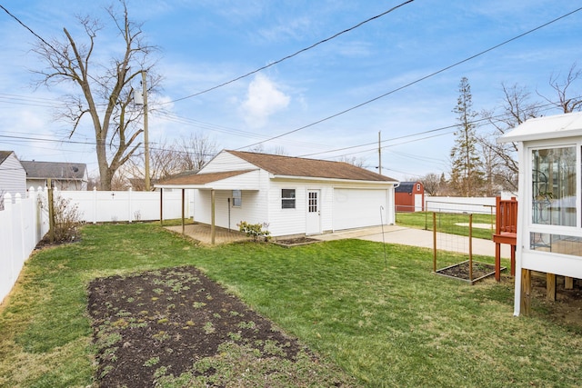 view of yard featuring a fenced backyard and a detached garage