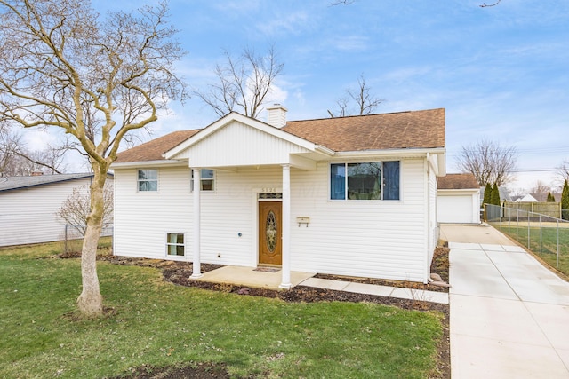 raised ranch featuring roof with shingles, a chimney, a front yard, and fence