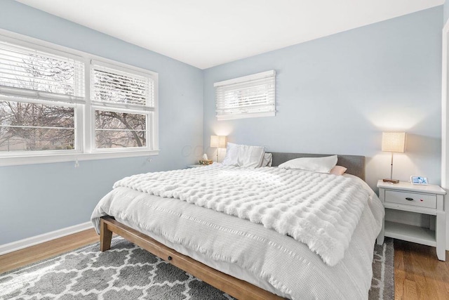 bedroom featuring baseboards and wood finished floors