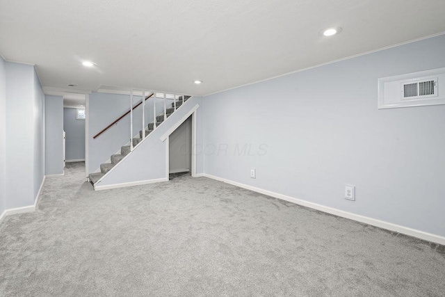 finished basement with carpet floors, recessed lighting, stairway, and baseboards