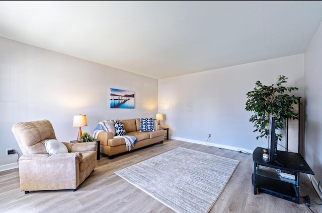 living room with light wood finished floors and baseboards