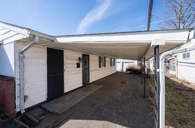 view of side of property with an attached carport and fence