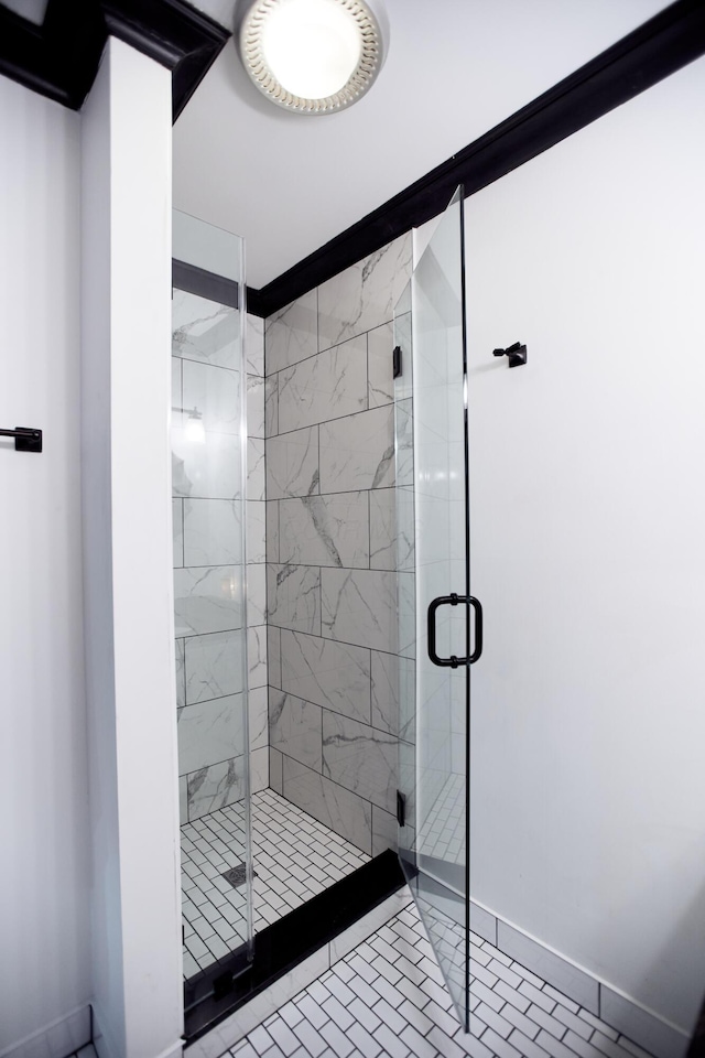 bathroom with a stall shower and baseboards