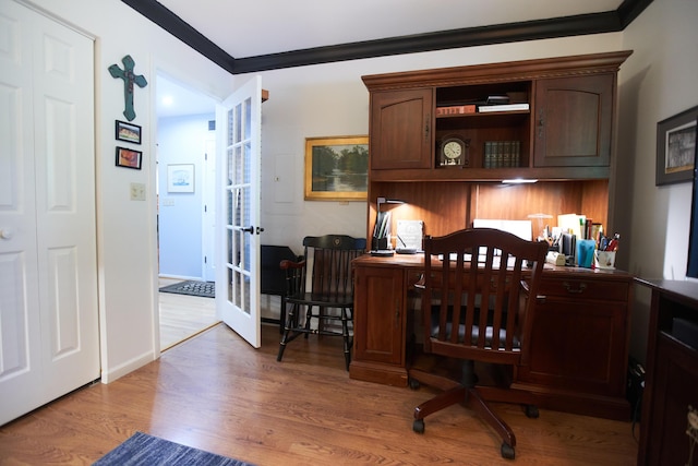 home office with baseboards, french doors, light wood-type flooring, and crown molding