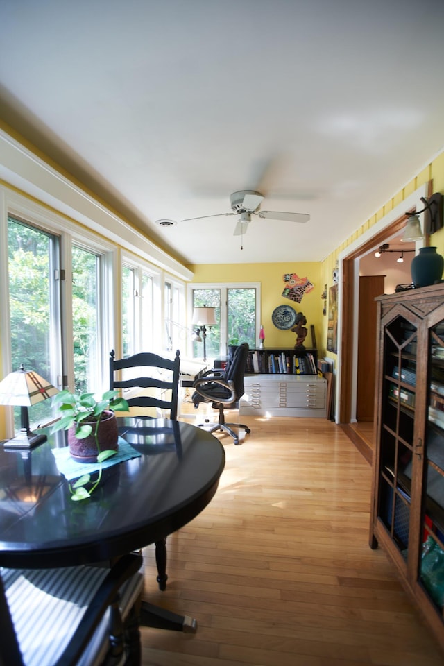 dining room with ceiling fan and wood finished floors