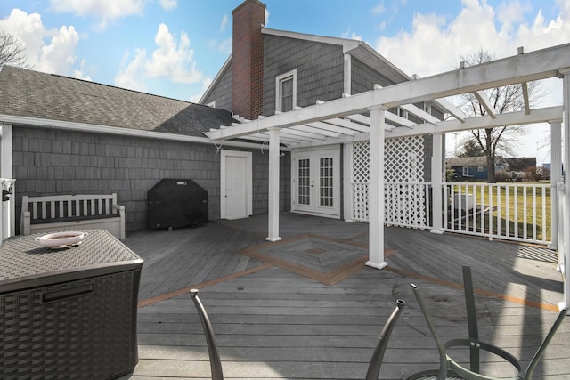 wooden deck featuring french doors, a grill, and a pergola