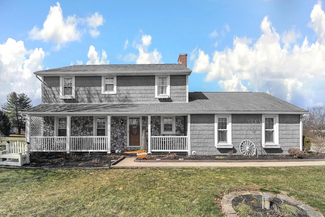 view of front of home with a shingled roof, a chimney, a porch, and a front yard