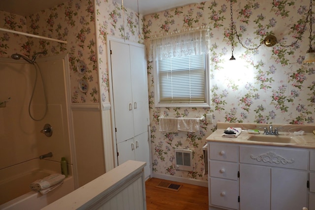 2930 County Road 184, Cardington, OH 43315 - full bath featuring wood finished floors, bathtub / shower combination, visible vents, and wallpapered walls