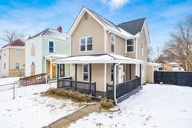 view of front of home featuring covered porch and fence