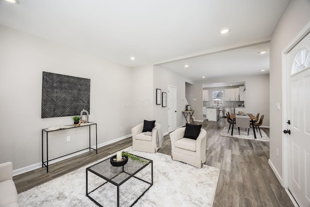 living area featuring wood finished floors and baseboards