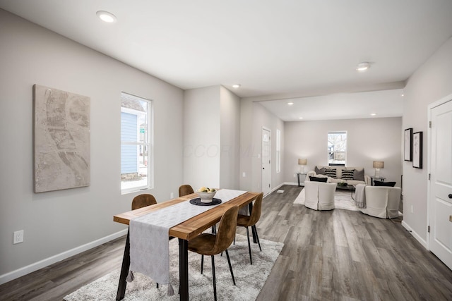 dining area with baseboards, wood finished floors, and recessed lighting