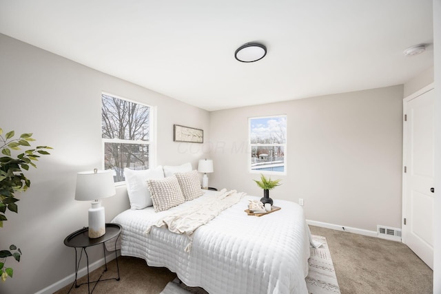 bedroom featuring carpet floors, baseboards, and visible vents