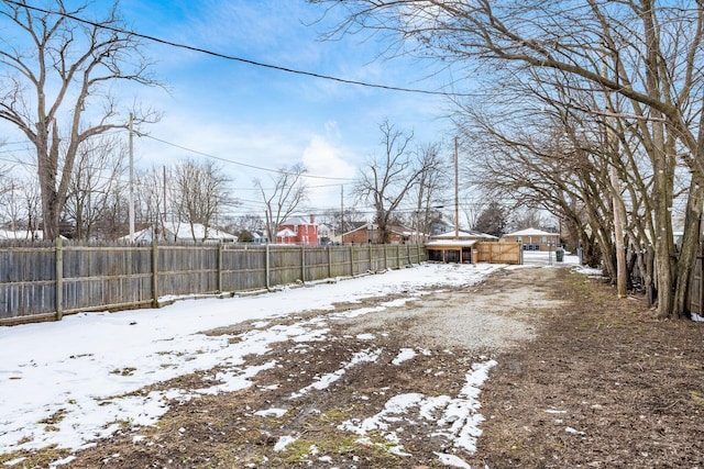 snowy yard with fence