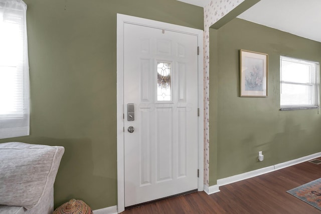 foyer with baseboards and dark wood-style flooring