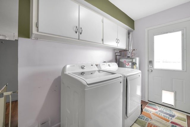 washroom featuring gas water heater, cabinet space, and independent washer and dryer