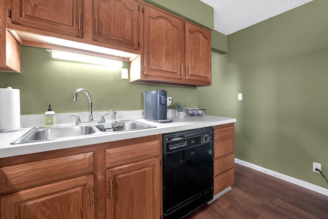 kitchen featuring baseboards, dishwasher, brown cabinets, light countertops, and a sink