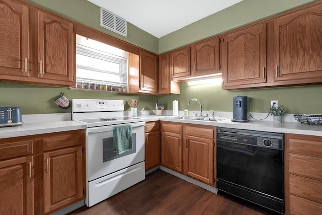 kitchen with black dishwasher, white electric stove, light countertops, visible vents, and a sink