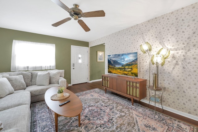 living area featuring wood finished floors, ceiling fan, baseboards, and wallpapered walls