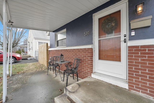 entrance to property featuring brick siding