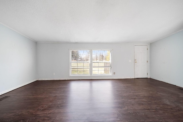 empty room featuring visible vents, crown molding, a textured ceiling, and wood finished floors