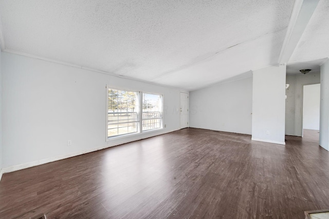 unfurnished room featuring dark wood-style floors, a textured ceiling, and baseboards