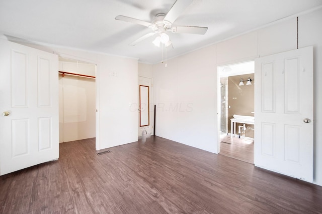 unfurnished bedroom featuring visible vents, a ceiling fan, ornamental molding, a closet, and dark wood-style floors