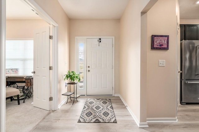 entrance foyer with light wood finished floors and baseboards