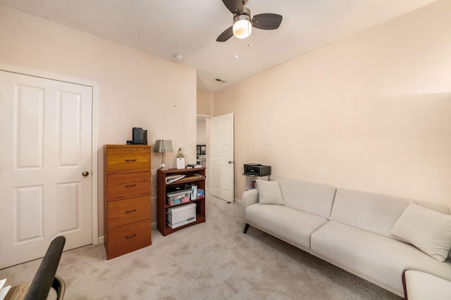 living area with light carpet, ceiling fan, and visible vents