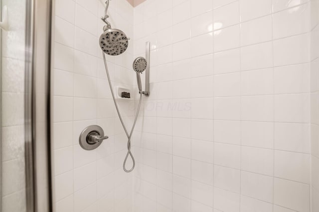 interior details featuring tiled shower