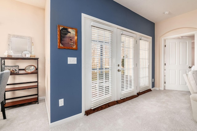 interior space with french doors, carpet, and baseboards