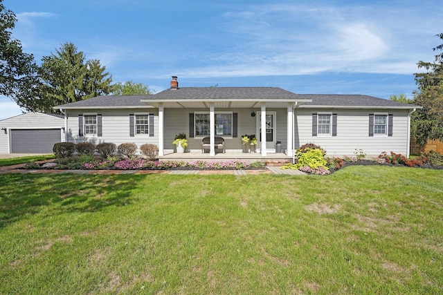 ranch-style home with an outbuilding, a porch, a garage, a chimney, and a front yard