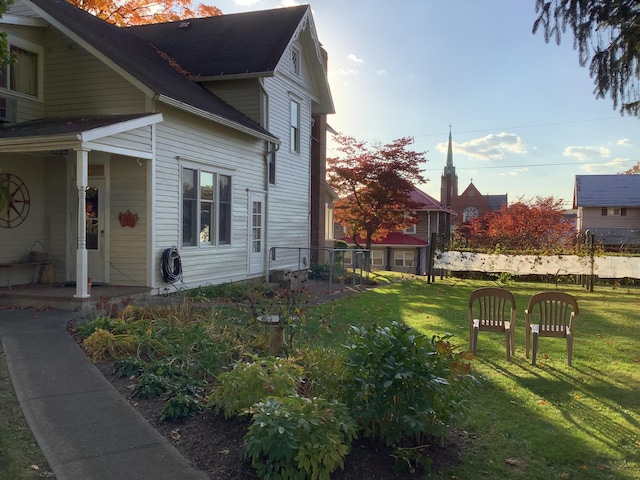 view of property exterior featuring a porch and a yard