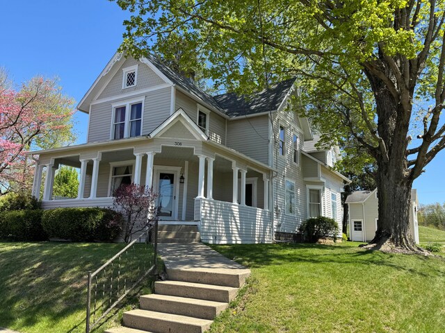 victorian house with covered porch and a front lawn