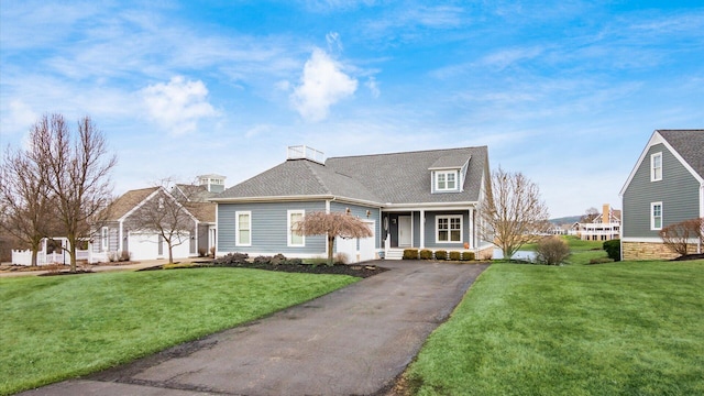 view of front of house featuring driveway and a front yard