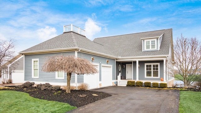 view of front facade featuring a garage, driveway, and a shingled roof