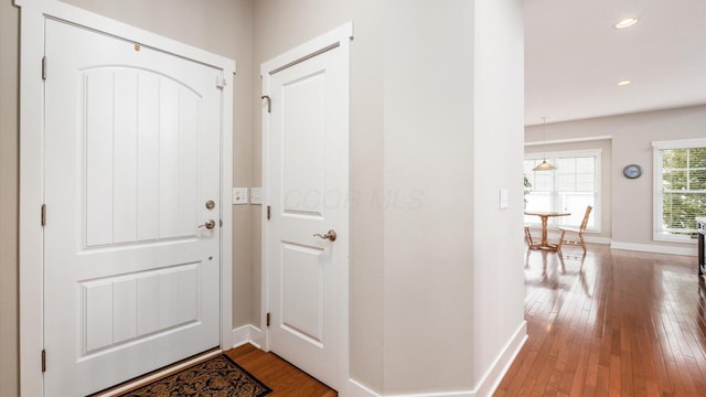 interior space featuring recessed lighting, baseboards, and hardwood / wood-style floors