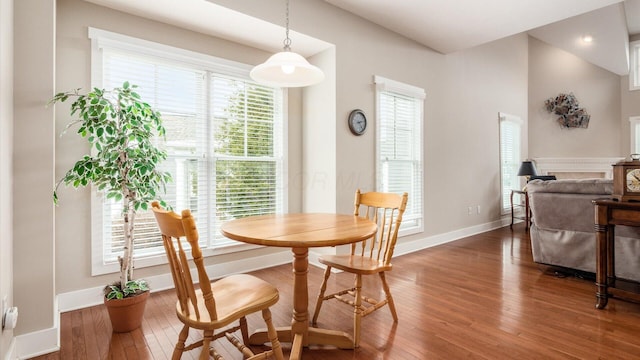 dining space featuring hardwood / wood-style flooring and baseboards