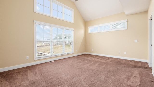 unfurnished room featuring carpet floors, high vaulted ceiling, and baseboards