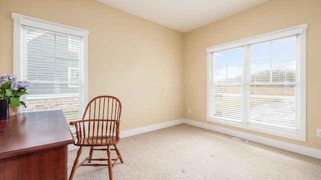 carpeted office with baseboards and visible vents