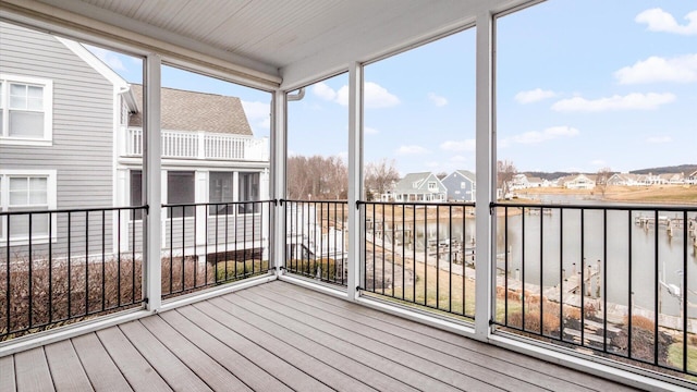 unfurnished sunroom featuring a residential view