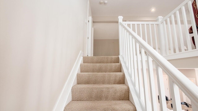 staircase with recessed lighting