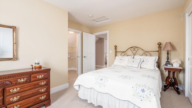 bedroom featuring baseboards, attic access, and light colored carpet