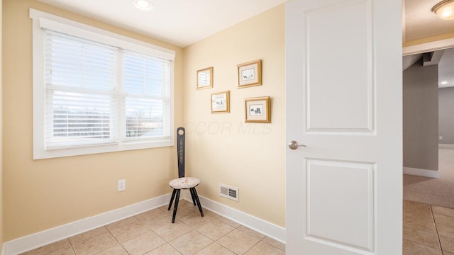 interior space with visible vents, baseboards, and light tile patterned floors