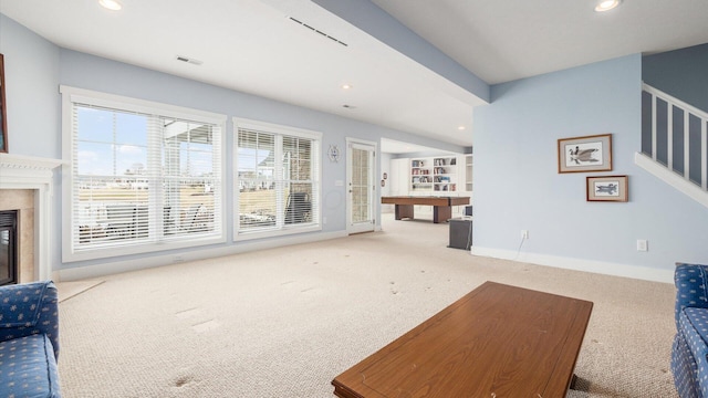 living room with baseboards, a premium fireplace, stairway, carpet flooring, and recessed lighting