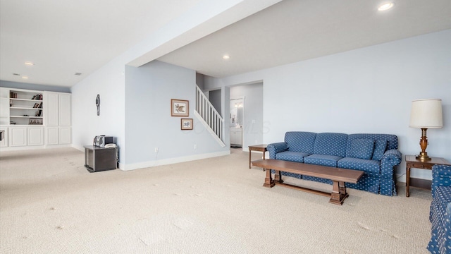 living area with carpet floors, recessed lighting, baseboards, and stairs