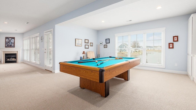 game room featuring a fireplace with flush hearth, light carpet, and plenty of natural light