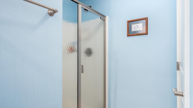 full bath featuring a shower stall