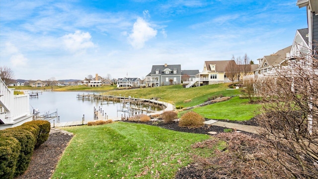 water view with a dock and a residential view